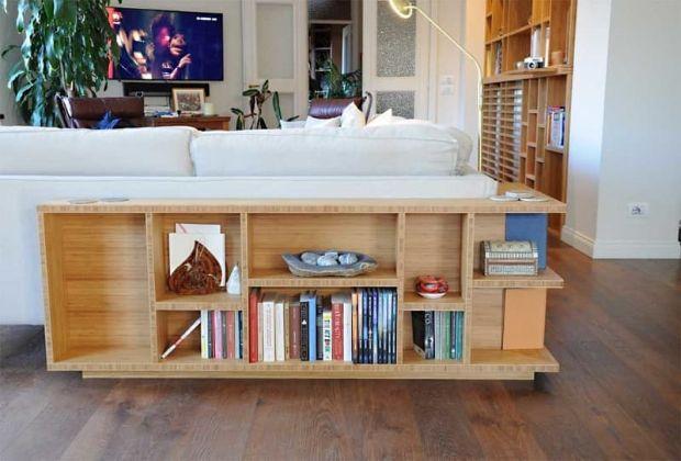 The low bookcase behind a made-to-measure sofa by Mauvri