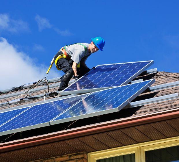 Installing solar cloths on a roof - Getty Images